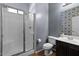 Bathroom features a glass-enclosed shower, tiled floors, and a decorative patterned accent wall at 5402 S 54Th Ln, Laveen, AZ 85339
