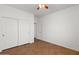 Bedroom features a ceiling fan and large closet with bi-fold doors at 5402 S 54Th Ln, Laveen, AZ 85339