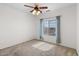 Bright bedroom with carpet, ceiling fan, and window offering scenic views at 5402 S 54Th Ln, Laveen, AZ 85339