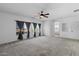 Very spacious bedroom featuring neutral carpet, a ceiling fan, and large windows at 5402 S 54Th Ln, Laveen, AZ 85339