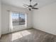 Carpeted bedroom with ceiling fan and window allowing natural light at 5402 S 54Th Ln, Laveen, AZ 85339