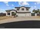 Charming two-story house features a three-car garage and landscaped front yard at 5402 S 54Th Ln, Laveen, AZ 85339