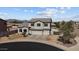 Two-story home with a three-car garage, landscaping, and a view of mountains at 5402 S 54Th Ln, Laveen, AZ 85339