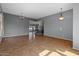 Open-concept living area features tile floors, elegant lighting, and staircase at 5402 S 54Th Ln, Laveen, AZ 85339