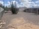 Low maintenance backyard with mature landscaping and a partial view of neighboring houses beyond the fence at 5702 E Casper Rd, Mesa, AZ 85205