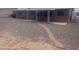 Backyard view showcases desert landscaping, a brick walkway, and a covered patio, enhancing outdoor living at 5702 E Casper Rd, Mesa, AZ 85205