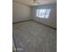 Neutral colored bedroom with bright natural light, fan, and marble-style flooring at 5702 E Casper Rd, Mesa, AZ 85205