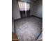 A standard bedroom with light gray paint, marble-style floors, and natural light from one window at 5702 E Casper Rd, Mesa, AZ 85205