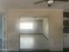 Neutral-toned living room features an open layout and ample natural light from the large window at 5702 E Casper Rd, Mesa, AZ 85205