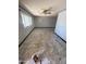 Spacious living room with a fan, neutral paint, marble style floors, and large window at 5702 E Casper Rd, Mesa, AZ 85205