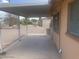 Covered patio providing a shaded outdoor space with low maintenance landscaping and privacy fencing at 5702 E Casper Rd, Mesa, AZ 85205