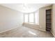 Spacious bedroom with a cozy window seat, lots of natural light, and a built in bookcase at 6126 W Paradise Ln, Glendale, AZ 85306