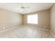 Simple and clean bedroom featuring tile flooring, ceiling fan, and natural light from a window at 6126 W Paradise Ln, Glendale, AZ 85306