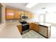 Well-equipped kitchen with stainless appliances, sleek countertops, tile backsplash, and ample cabinet storage at 6126 W Paradise Ln, Glendale, AZ 85306