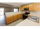 Functional kitchen featuring stainless steel appliances, wooden cabinets, and lots of countertop space at 6126 W Paradise Ln, Glendale, AZ 85306