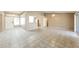 Spacious open-concept living area with neutral paint, tile flooring, and seamless flow to kitchen at 6126 W Paradise Ln, Glendale, AZ 85306