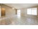 Bright and airy living room featuring tile flooring, sliding glass doors, and a ceiling fan at 6126 W Paradise Ln, Glendale, AZ 85306