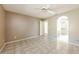 Large main bedroom featuring neutral paint, tile flooring, ceiling fan, and en-suite bathroom at 6126 W Paradise Ln, Glendale, AZ 85306