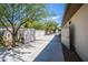 View of the gated backyard area, offering security and privacy, with lush greenery, mature trees, a block wall and a desert landscape at 6334 E Albany St, Mesa, AZ 85205