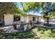 Backyard features a custom stone barbecue island, mature trees, and well-maintained lawn at 6334 E Albany St, Mesa, AZ 85205