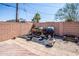 A fenced-in backyard with tile pavers and garden beds, offering a private outdoor space at 6334 E Albany St, Mesa, AZ 85205