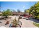 Outdoor area with brick patio, firepit, seating, and lovely landscaping at 6334 E Albany St, Mesa, AZ 85205