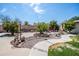 Landscaped backyard with mature trees, stone walkway, and relaxing seating areas at 6334 E Albany St, Mesa, AZ 85205