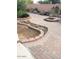 Backyard featuring brick patio, custom fire pit, and comfortable seating for outdoor enjoyment at 6334 E Albany St, Mesa, AZ 85205