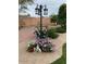 Charming backyard garden with flowers around a decorative lamppost and bunny statues at 6334 E Albany St, Mesa, AZ 85205