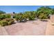 Spacious backyard featuring brick pavers, mature trees, and central fire pit for outdoor gatherings at 6334 E Albany St, Mesa, AZ 85205