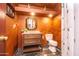 Well-lit bathroom with vanity sink, toilet, and tiled flooring and a bronze color scheme at 6334 E Albany St, Mesa, AZ 85205