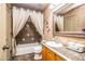 A neutral bathroom featuring a vanity and shower with curtains at 6334 E Albany St, Mesa, AZ 85205