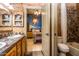 Unique bathroom featuring a tile countertop, double sink, and dolphin decor leading to a bedroom with custom tropical wall mural at 6334 E Albany St, Mesa, AZ 85205