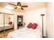 Bright bedroom with ceiling fan, skylight, and large closet featuring mirror doors at 6334 E Albany St, Mesa, AZ 85205