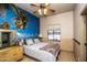 Bedroom with a tropical mural and double door closet at 6334 E Albany St, Mesa, AZ 85205