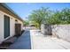 Long, gated driveway leading to the property, offering privacy, security and desert landscape with mature trees at 6334 E Albany St, Mesa, AZ 85205