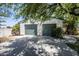Exterior view of a detached two car garage with green doors and mature trees at 6334 E Albany St, Mesa, AZ 85205