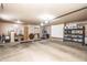 Well-lit and organized two car garage with ample storage, including cabinets, shelving and a water heater at 6334 E Albany St, Mesa, AZ 85205