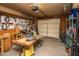 Organized garage with tools, workbench, shelving, and garage door. Great for projects! at 6334 E Albany St, Mesa, AZ 85205