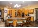 Spacious kitchen featuring abundant cabinetry, granite countertops, and a breakfast bar with seating at 6334 E Albany St, Mesa, AZ 85205