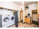 Functional laundry room with washer, dryer, cabinets, and folding screen, offering convenience and organization at 6334 E Albany St, Mesa, AZ 85205