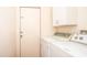 Laundry area with washer, dryer, storage cabinet, and access to the outside at 6334 E Albany St, Mesa, AZ 85205
