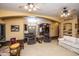Spacious living room featuring a mix of carpet and tile, ceiling fans, and neutral decor at 6334 E Albany St, Mesa, AZ 85205