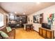 Cozy living room with kitchen view, breakfast bar, and rustic-themed decor at 6334 E Albany St, Mesa, AZ 85205