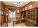Inviting office with custom wood built-ins, earth tone decor, and a cozy atmosphere at 6334 E Albany St, Mesa, AZ 85205