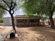 Rustic exterior view with mature trees and a quaint yard, featuring a unique design at 660 S 93Rd St, Mesa, AZ 85208
