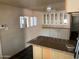 Kitchen area with tile countertops, ample storage, and a quaint breakfast bar at 660 S 93Rd St, Mesa, AZ 85208