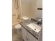 Bathroom featuring granite countertop, white cabinets, and shower-tub combo at 7040 W Olive Ave # 94, Peoria, AZ 85345