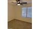 Cozy bedroom with neutral carpet, ceiling fan, and natural lighting at 7040 W Olive Ave # 94, Peoria, AZ 85345