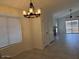 Open dining room with modern chandelier and easy access to the outdoor space at 7040 W Olive Ave # 94, Peoria, AZ 85345